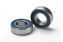 Two Traxxas 8x16x5mm rubber shielded ball bearings with silver metal outer rings and blue rubber seals.