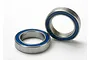 Two Traxxas rubber-shielded ball bearings with blue seals and silver metal outer rings on a white background.