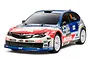 A 1/10 scale Tamiya Subaru Impreza WRX STI RC rally car model with blue, white, and red livery, featuring Motul and Yokohama sponsor decals.