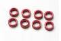 Eight small red anodized aluminium spacers arranged in two rows of four on a white background.