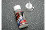 A bottle of Traxxas 50K weight differential oil with a separate nozzle cap, sitting on a textured grey surface.