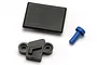 Traxxas Revo forward only conversion parts including a black rectangular cover, a black mounting plate, and a small blue plastic plug.