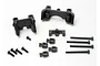 Traxxas shock mount set including two main plastic mounts, smaller plastic components, and various metal screws on a white background.