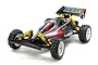 A fully assembled Tamiya VQS 1/10 scale RC buggy with a black, silver, and red body, yellow shock absorbers, and off-road tires on a white background.