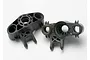 Two black plastic Traxxas axle carriers for RC vehicles, shown from different angles on a white background.