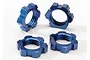 Four blue anodized aluminium 17mm splined wheel nuts for Traxxas RC vehicles arranged on a white background.