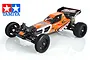 Tamiya DT-03 Racing Fighter 1/10 scale RC buggy kit in orange and black with racing decals, shown from a front three-quarter angle.