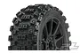 A close-up of a Pro-Line Badlands MX tyre mounted on a black Mach 10 rim, showing the aggressive tread pattern and wheel design.