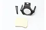 Traxxas ESC hold down bracket for Mamba Monster, including two black screws and a piece of adhesive foam, on a white background.