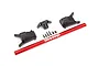 Traxxas red aluminium chassis brace with black plastic mounting components and screws on a white background.
