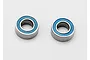 Two small metal ball bearings with blue rubber seals sitting on a white background.