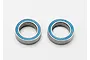 Two Traxxas rubber-shielded ball bearings with blue seals on a white background.