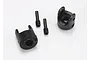 Two black plastic differential output yokes and two metal grub screws for Traxxas RC vehicles.