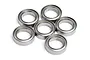 Six silver metal ball bearings arranged in a cluster on a white background.