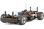 A HPI Sprint 2 RC car chassis shown without its body shell, featuring a black plastic frame, orange shock absorbers, and silver wheels on a white background.