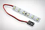 A small LED light strip for an RC car with six surface-mounted LEDs on a white circuit board, connected to a black two-pin connector by red and black wires.