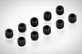 Ten small black metal grub screws with hexagonal sockets arranged on a white background.