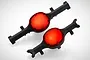 Two black RC axle housings with bright red circular differential covers, viewed from an elevated angle against a white background.