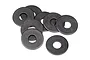 A small pile of eight dark grey metal washers on a white background.