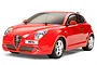 A 1/10 scale Tamiya RC car model of a red Alfa Romeo MiTo, featuring a detailed polycarbonate body shell, silver wheels, and black rubber tires.
