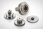 A set of four metallic RC servo gears of varying sizes arranged on a white background.