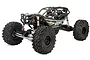 Axial RBX10 Ryft 4X4 rock bouncer RC car in black, featuring a tube chassis, large off-road tires, and detailed driver figures.