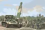 Box art illustration of a Russian BREM-1M armoured recovery vehicle with a crane, assisting another tank in a field with soldiers.