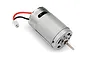 A silver brushed 390-size electric motor for RC vehicles with red and black wires and a small white connector.