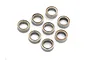 A set of eight small metal ball bearings with rubber seals arranged on a white background.