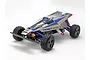 A studio shot of the Tamiya Thunder Dragon 1/10 scale 4WD RC buggy kit, featuring a silver body with blue and red decals and a driver figure.