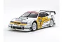 A Tamiya 1/10 scale RC Opel Calibra V6 touring car model with white, yellow, and black racing livery on a plain white background.
