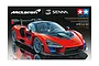 Box art for Tamiya 1/24 scale McLaren Senna plastic model kit featuring a red sports car on a black background.