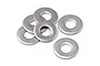 A cluster of six small silver metal washers arranged on a white background.