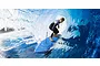 Kyosho 1/5 Surfer 4 RC boat in blue riding a large ocean wave with a surfer figure attached.