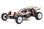 Kyosho Ultima 1/10 scale 2WD electric RC buggy in white, orange, and black livery with white wheels and red shock absorbers.