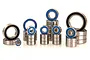 A collection of various sized metal ball bearings with blue rubber seals arranged in stacks on a white background.