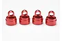 Four red anodized aluminium shock caps for Traxxas Ultra Shocks arranged in a row on a white background.