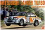 Box art for a NuNu 1/24 scale Mitsubishi Lancer Turbo model kit depicting the car in action at the 1982 Rally of 1000 Lakes.