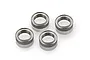 Four Tamiya metal shielded ball bearings arranged on a white background.