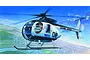 Box art illustration of a California Highway Patrol Hughes 500D helicopter flying over a city landscape.