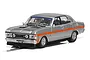 A 1/32 scale Scalextric Ford XW Falcon slot car in silver with an orange side stripe and black hood detail, shown on a white background.