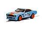 A 1/32 scale Scalextric Aston Martin V8 slot car in Gulf livery, featuring light blue paint with orange accents and the number 19 on the hood and doors.