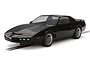 A 1/32 scale Scalextric model of the black Knight Rider KITT car sitting on a slot car track against a white background.