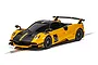 A yellow and black Scalextric 1/32 scale Pagani Huayra BC Roadster slot car on a track.