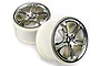 Two Traxxas 3.8 inch split-spoke RC monster truck rims with a satin chrome finish and white plastic barrels.