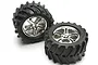Two Traxxas 3.8 inch Maxx Chevron monster truck tires pre-glued onto chrome split-spoke wheels, shown against a white background.