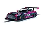 A 1/32 scale Scalextric Mercedes AMG GT3 slot car in black and pink livery with number 69, sitting on a slot car track.