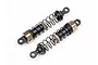 Two Maverick Ion RC shock absorbers with black plastic bodies, metal springs, and bronze-coloured adjustment collars on a white background.
