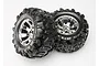 Two Traxxas 3.8 inch Canyon AT monster truck tires pre-glued onto shiny chrome Geode wheels against a plain white background.