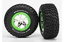 Two Traxxas RC short course wheels with BFGoodrich Mud-Terrain T/A KM2 tyres mounted on chrome and green rims against a white background.